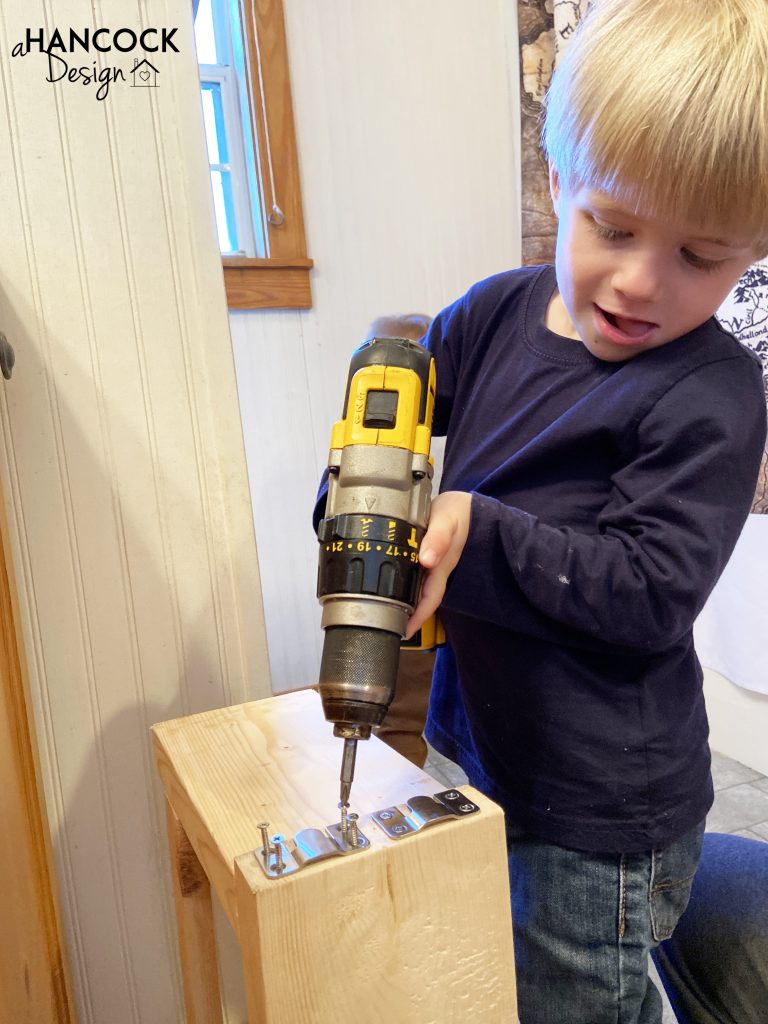 little boy using drill